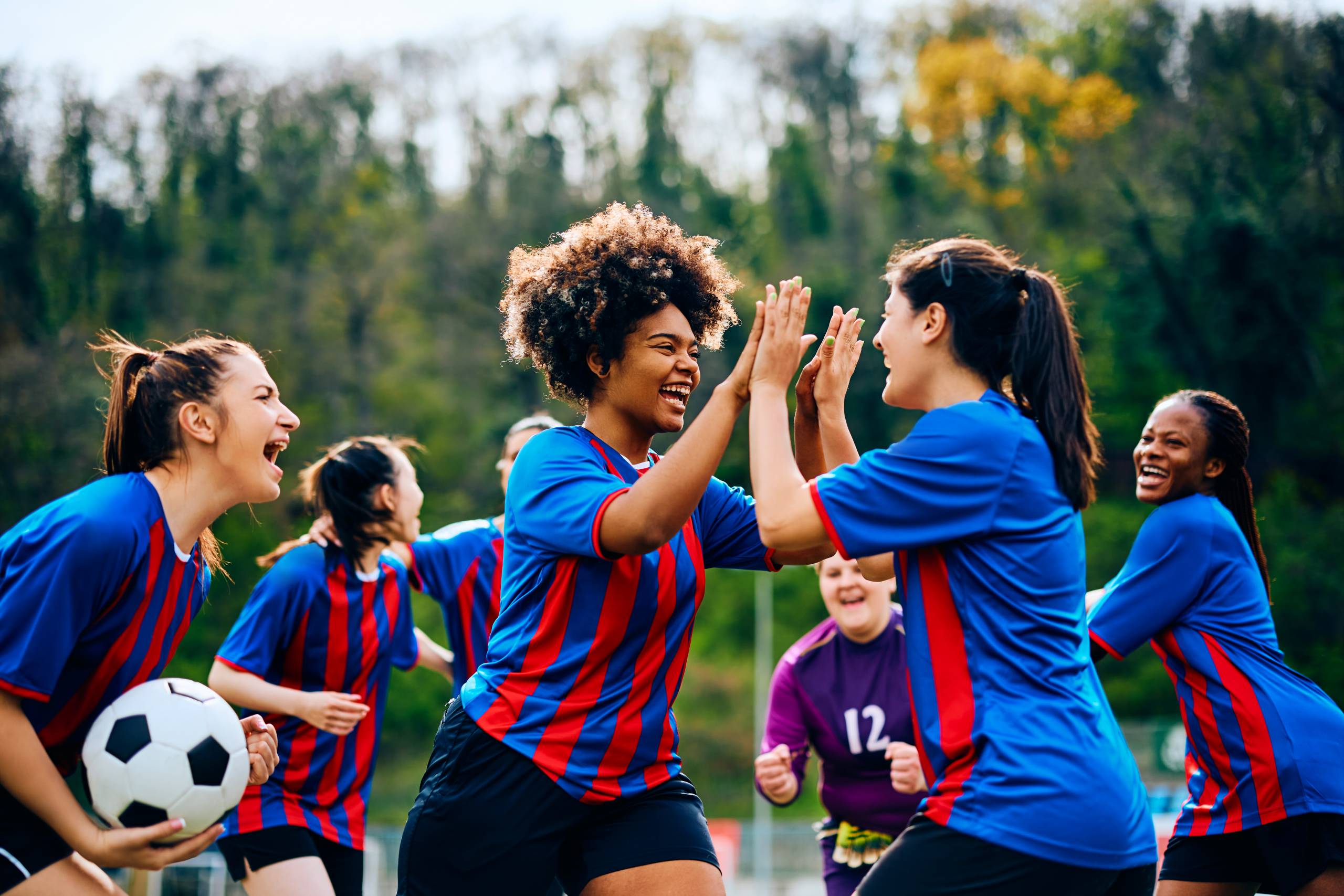 Women’s football team celebrating together